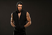 Portrait of muscular man in hooded vest