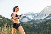 United States, Utah, American Fork, Athlete woman jogging in mountain landscape