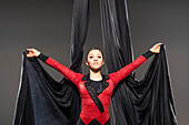 Teenage girl (14-15) performing aerial silk 