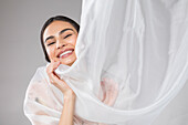Beautiful woman wrapped in tulle fabric