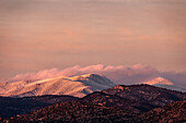 United States, New Mexico, Santa Fe, Evening light over snowcapped Sangre de Cristo mountains