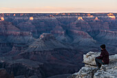 United States, Arizona, Grand Canyon National Park, South Rim, Senior female hiker sitting on rock