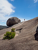 Australia, Queensland, Girraween National Park, Woman hiking on rock formation