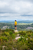 Australia, New South Wales, Bald Rock National Park, Man standing on rock and looking around