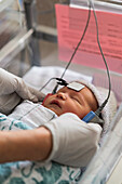 Infant baby girl (0-1 months) having hearing test done
