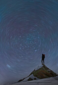 France, Haute Savoie, Chamonix, Mont Blanc, Climber standing on top of Mont Blanc and watching star trails