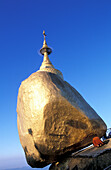 Myanmar, Mon State, Kyaiktiyo, Buddhist monk praying at Kyaiktiyo Pagoda built on top of granite boulder