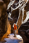 USA, Utah, Escalante, Woman hiking in slot canyon in Grand Staircase-Escalante National Monument