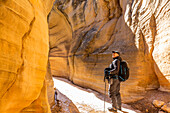 USA, Utah, Escalante, Man hiking in slot canyon in Grand Staircase-Escalante National Monument