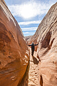 United States, Utah, Escalante, Senior hiker walking in sandstone canyon