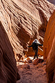 United States, Utah, Escalante, Senior hiker exploring slot canyon
