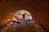 USA, Utah, Zion National Park, Female hiker walking through tunnel