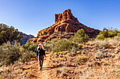United States, Arizona, Sedona, Senior blonde woman hiking in wilderness