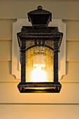 Electric lamp hanging on porch