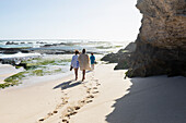 South Africa, Western Cape, Mother with boy (8-9) and girl (16-17) walking on beach in Lekkerwater Nature Reserve