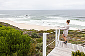 South Africa, Western Cape, Girl (16-17) looking at ocean view in Lekkerwater Nature Reserve