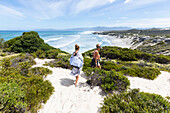 South Africa, Western Cape, Mother and daughter (16-17) exploring beach in Walker Bay Nature Reserve