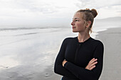 Portrait of girl (16-17) wearing wetsuit on Grotto Beach