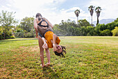 South Africa, Western Cape, Stanford, Girl (16-17) and boy (8-9) playing with water on lawn