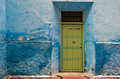 Africa, Morocco, Colorful blue walls and old door in alleyway in medina