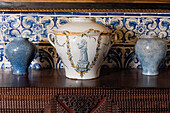 Antique Portuguese clay pots with blue tile background