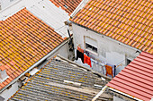 Portugal, Lisbon, Tile rooftops and hanging laundry