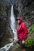 Russia , Karachay-Cherkessia, Arkhyz, Caucasus mountains, Hiker standing near waterfall