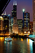 Chicago River and skyline at dusk with boat