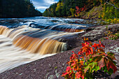 USA, Michigan. Fall colors at Presque Isle River waterfall on the south shore of Lake Superior.