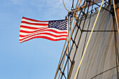 United States flag flying on Hawaiian Chieftain, a Square Topsail Ketch. Owned and operated by the Grays Harbor Historical Seaport, Aberdeen, Washington State