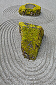 USA, Washington State, Bainbridge Island. Raked sand around rock