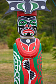 Kwakwaka'wakw totem poles in the cemetery in Alert Bay, Cormorant Island, British Columba, Canada, North America
