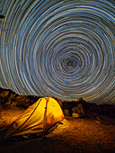 Night view of a pitched tent in the Alabama Hills National Scenic Area, and star trails, California, United States of America, North America