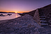 Sunrise at the harbour wall known as The Cobb in Lyme Regis, Dorset, England, United Kingdom, Europe