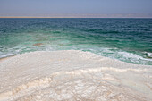 Shore with salt crystalized formation and turquoise water, The Dead Sea, Jordan, Middle East