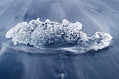 Chunk of ice washed by sea, Diamond beach near Jokulsarlon glacier lagoon, Iceland, Polar Regions