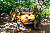 Farmworker and cowboy debating in a break by an old reconstructed car, near Trinidad, Cuba, West Indies, Caribbean, Central America
