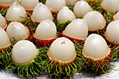Cut red rambutan on a plate, exotic fruit, Vietnam, Indochina, Southeast Asia, Asia