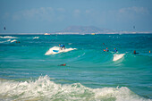 View of surfboarders and the Atlantic Ocean, Corralejo Natural Park, Fuerteventura, Canary Islands, Spain, Atlantic, Europe
