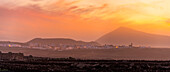View of Tinajo and mountains in background at sunset, Tinajo, Lanzarote, Las Palmas, Canary Islands, Spain, Atlantic, Europe