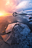 The Vestrahorn reflected in the bay during a winter sunrise, Austurland, Southern Iceland, Europe