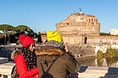 Tourists taking pictures of the castel sant angelo, tourism, rome, italy