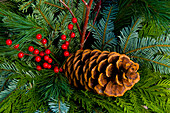 Christmas wreath with pine cone and berries.