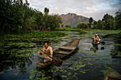 Men on a boat in Dal lake in Srinagar