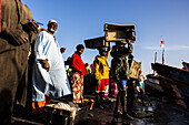 Fish market morning in Saint_Louis when the canoes arrive loaded with fish from the Atlantic ocean to sell it