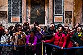 Tourists inside the Pantheon temple looking at the dome