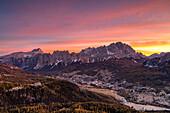 The tourist resort of Cortina d'Ampezzo with the Cristallo, Pomagagnon and Croda Rossa in the background at dawn, Belluno province, Boite Valley, Veneto, Italy
