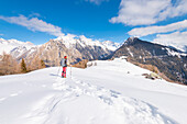 Alpinist is admiring Preda Rossa Valley, Valtellina, province of Sondrio, Lombardy, Italian alps, Italy