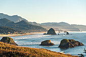 View of rock formations and Haystack Rock of Cannon Beach from Ecola State Park. Clatsop county, Oregon, USA.