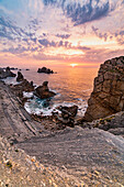 Rocky beach in the cantabrian sea of Costa Quebrada at sunset. Playa del Portio, Liencres, Cantabria, Spain, Europe.